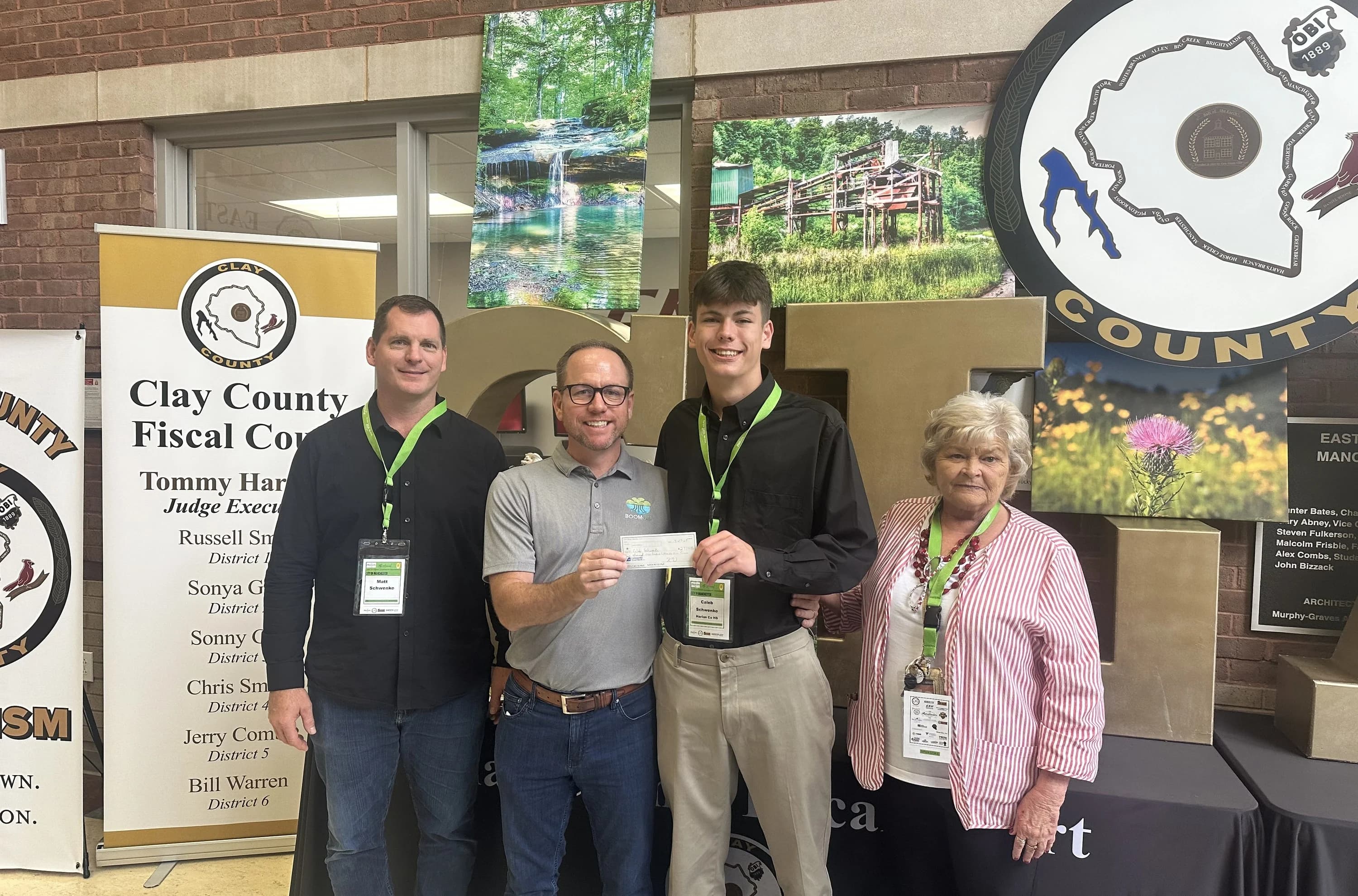 Boom student receiving seed capital check at Clay County pitch event
